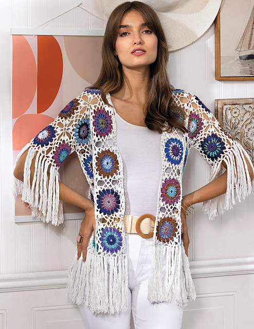 Front view of the Whelk crochet cardigan by Kyla Zoran, featuring colorful circular motifs joined with openwork lace and finished with long fringe
